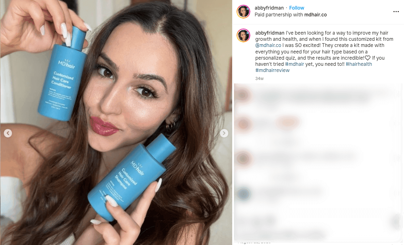 Instagram post from creator abbyfridman, marked as a paid partnership with MDhair, holding customized MDhair shampoo and conditioner bottles and praising the personalized hair kit.